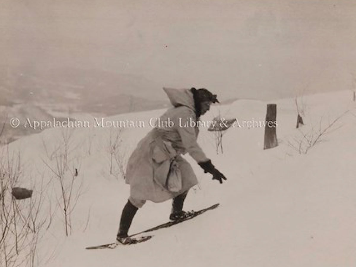Woman ascending a hill in snowshoes