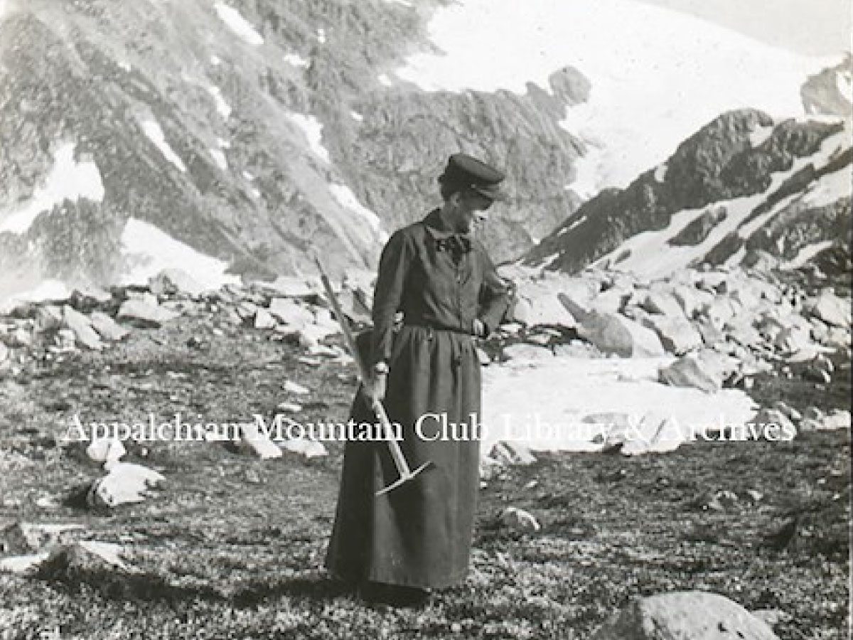 Woman standing with an ice axe