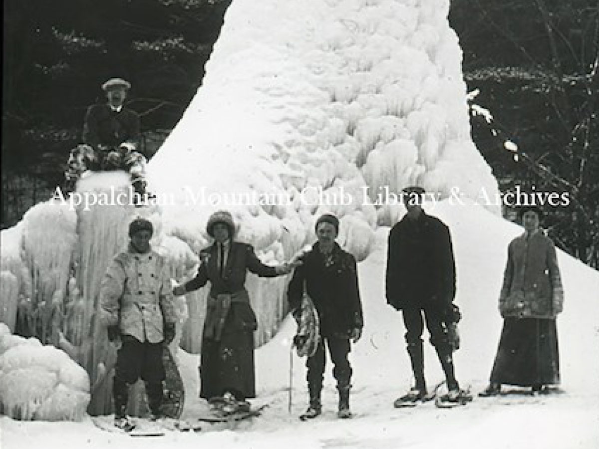 Snowshoers in front of an ice fountain