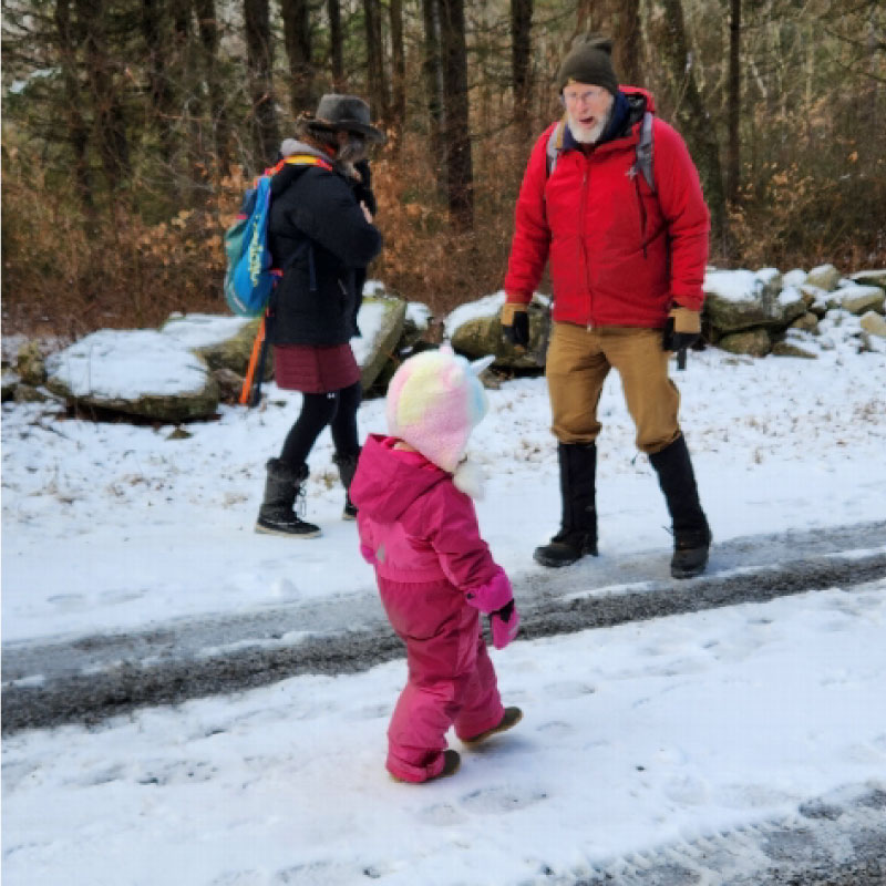 Family walking along a snowy road