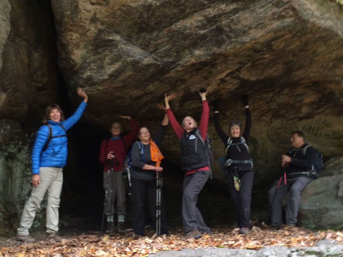 Trail workers pretending to hold up ledge