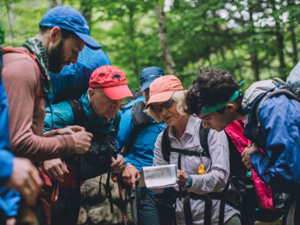 A group of hikers examine a map