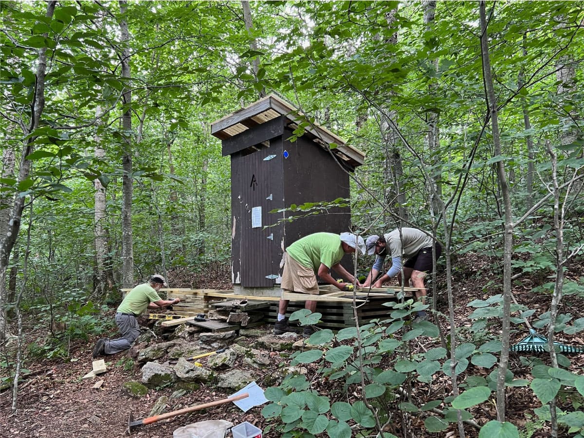 AT Committee crews repairing a privy