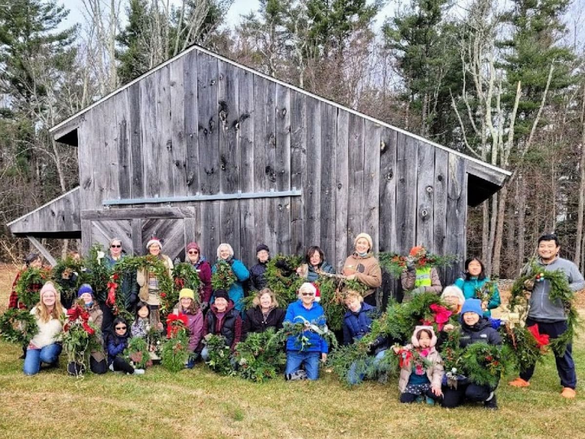 Workshop participants display their handmade holiday decorations