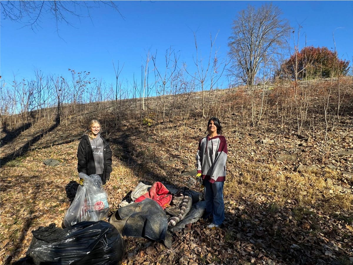 Workers clear trash near the Westfield River