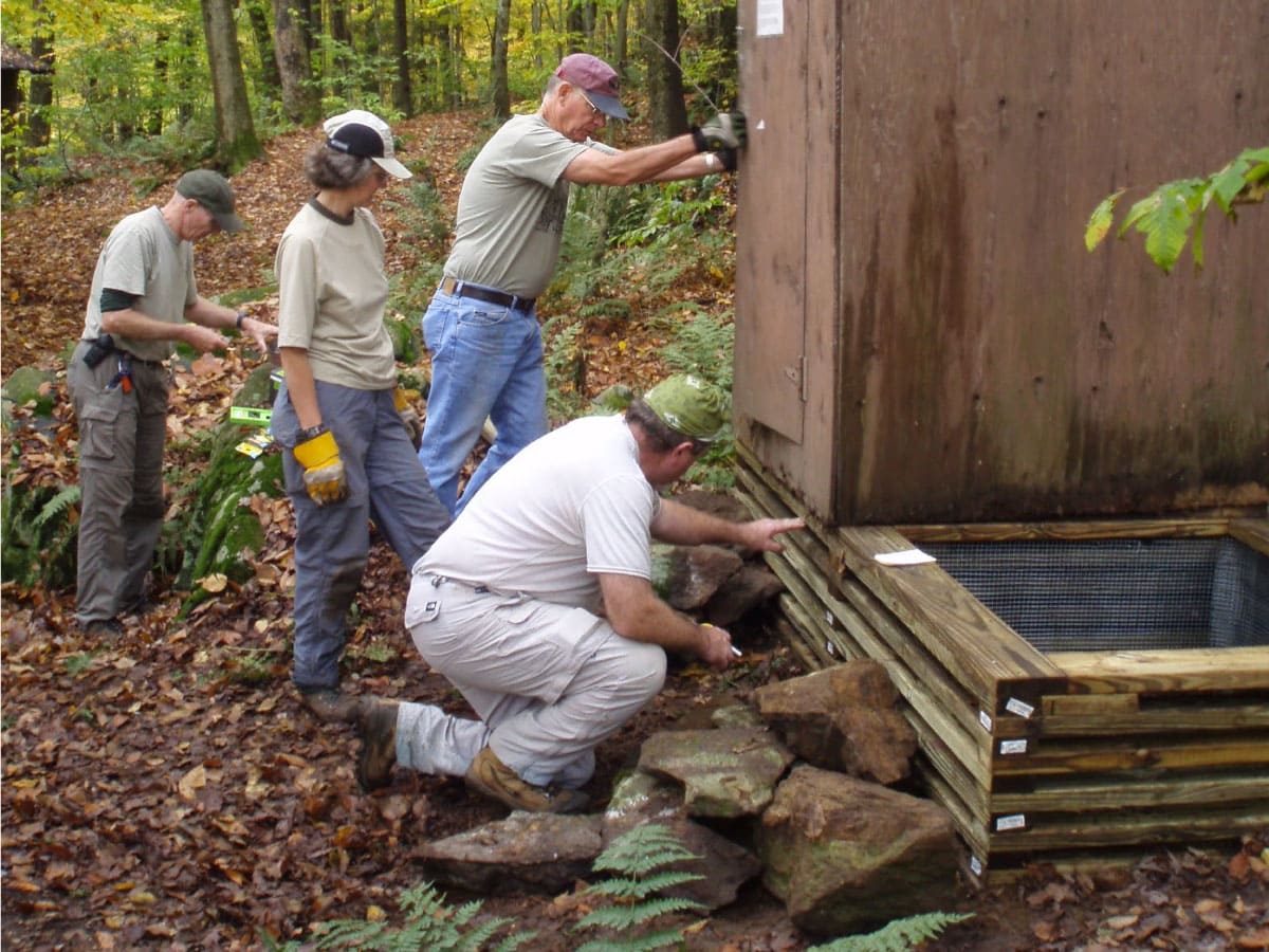 Workers providing final touches to the Kay Wood Shelter privy