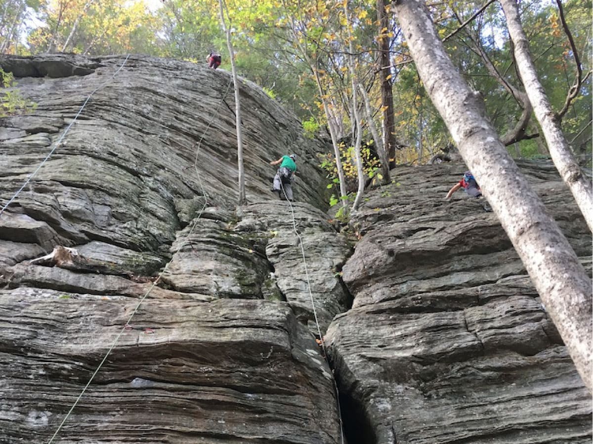 Mountaineers scaling a cliff