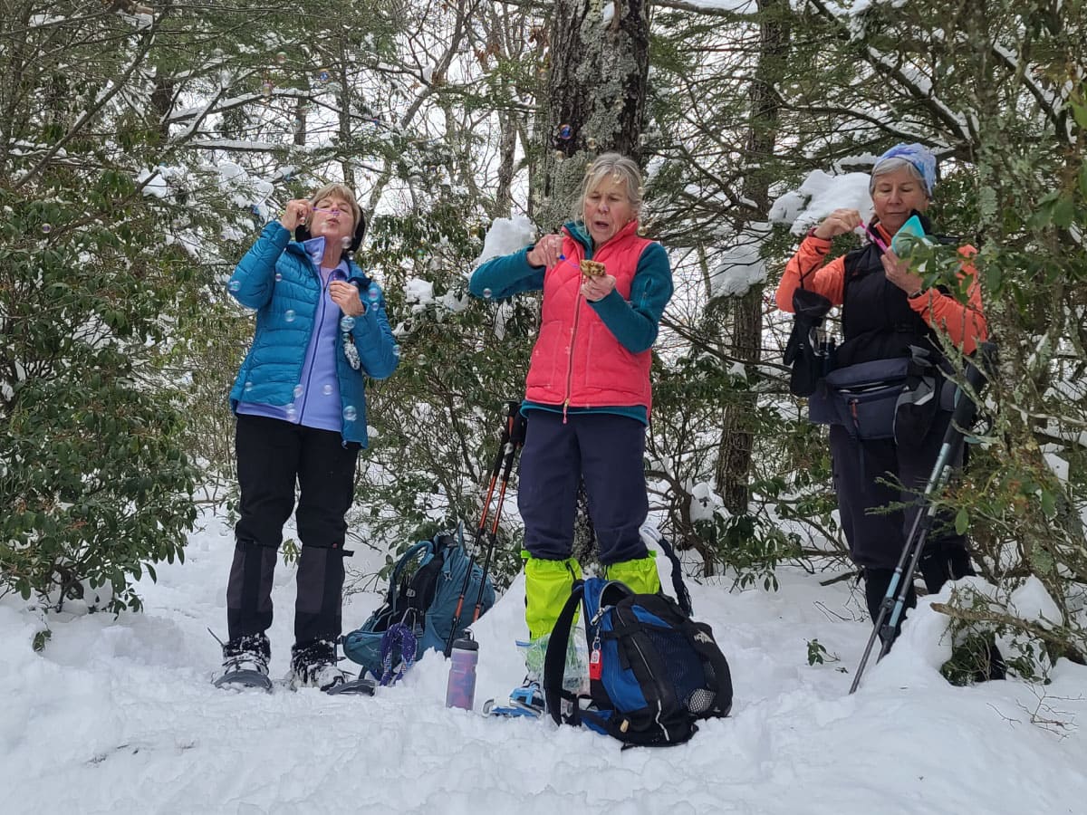 Snowshoers blowing bubbles