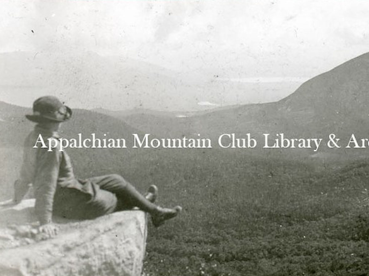 A woman seated on a rocky outcrop