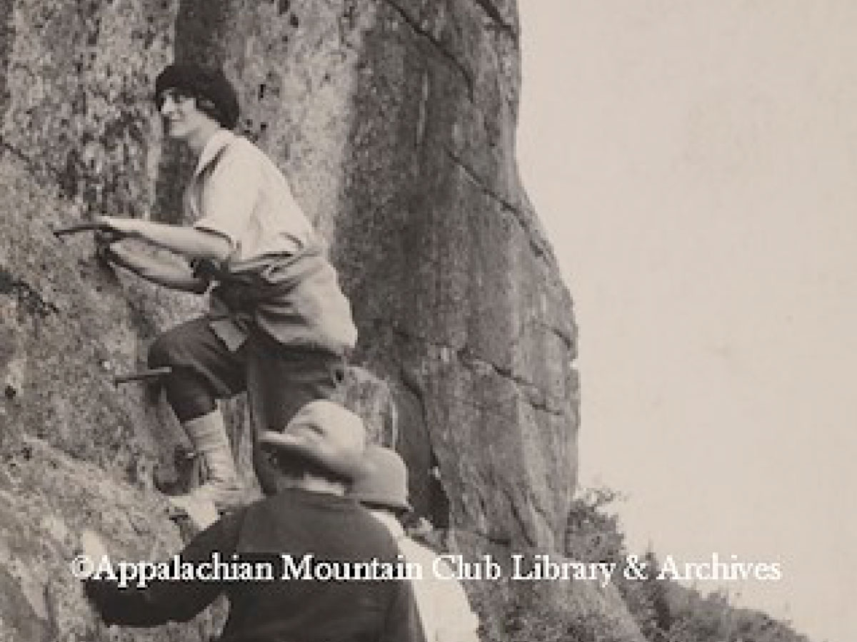 Women climbing iron rungs on a trail